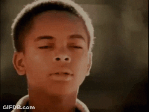 Close Up Of Young Boy Face On Black Background GIF