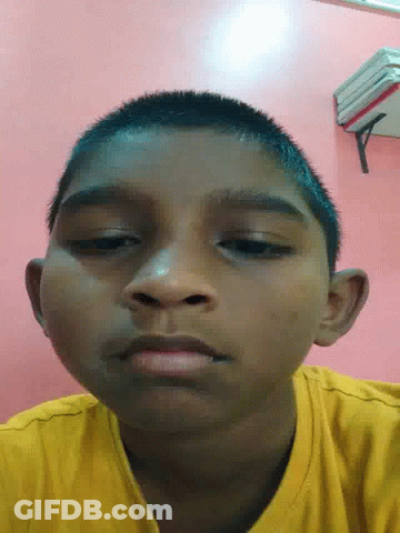 Close Up Of Young Boy's Face On Pink Background GIF