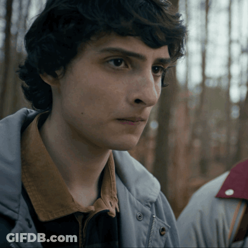 Close Up Of Young Man's Face In Gray Jacket GIF