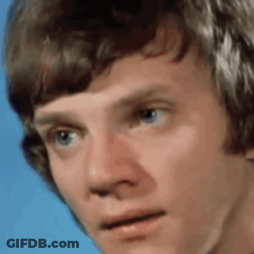 Close Up Of Young Man's Face On Blue Background GIF
