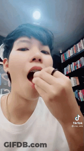 Close-Up Person Eating With Ring In Mouth GIF