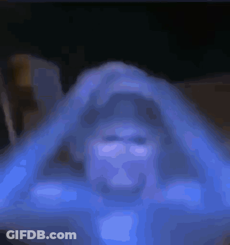 Close Up Person Face Dark Room Blue Background GIF