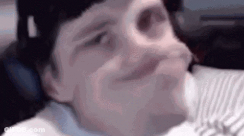 Close Up Person Making Funny Face On Bed GIF