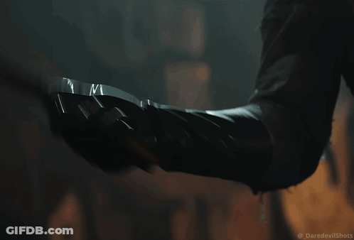 Close Up Person's Arm With Daredevil Shots GIF