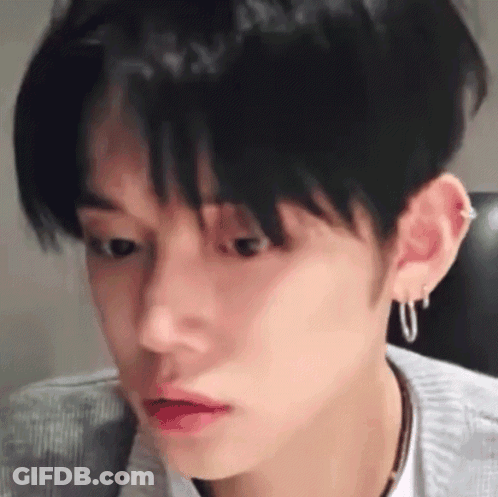 Close-Up Person's Face With Earrings And Necklace GIF