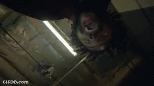 Close Up Person's Head Hanging From Ceiling GIF
