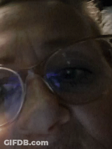 Close Up Person With Glasses And Blue Light GIF