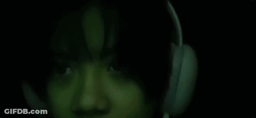 Close Up Person With Headphones In Dark Room GIF