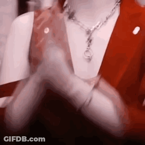 Close Up Person With Necklace And Red Vest GIF