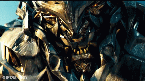 Close Up Robot With Red Eyes And Sharp Teeth GIF