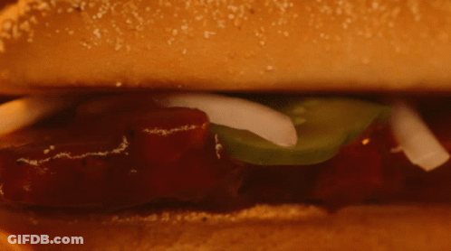 Close Up Sandwich With Meat And Vegetables On Bun GIF