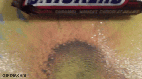 Close Up Snickers Bar Yellow Surface GIF