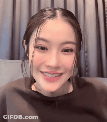 Close Up Woman's Face Gray Curtain GIF
