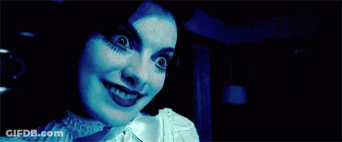 Close Up Woman's Face In Dark GIF
