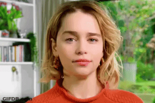 Close Up Woman's Face In Orange Sweater GIF