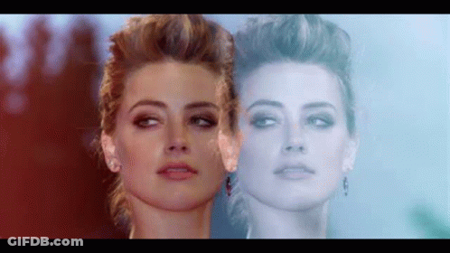 Close Up Woman's Face Reflecting Another's Face GIF