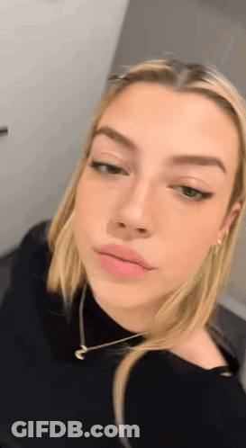 Close Up Woman's Face Wearing Necklace GIF