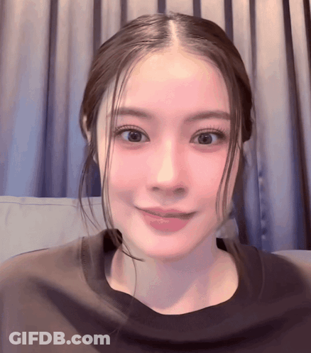 Close Up Woman's Face With Pink Curtain GIF