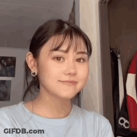 Close Up Woman's Face With Ponytail And Earrings GIF
