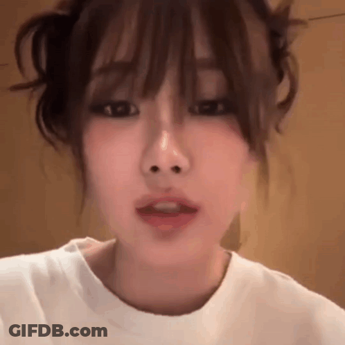 Close Up Woman's Face With White Shirt And Bun GIF