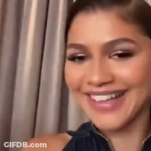 Close Up Woman Smiling In Front Of Curtain GIF