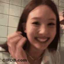 Close Up Woman Smiling In Front Of Tile Wall GIF