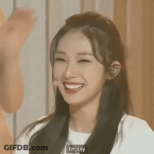 Close Up Woman Smiling Saying I'm Shy GIF