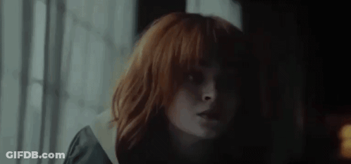 Close Up Woman With Red Hair And Bangs GIF
