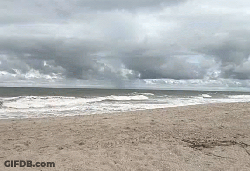 Cloudy Beach With Crashing Waves GIF