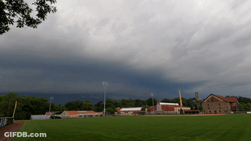 Cloudy Sky Over Baseball Field With Buildings GIF