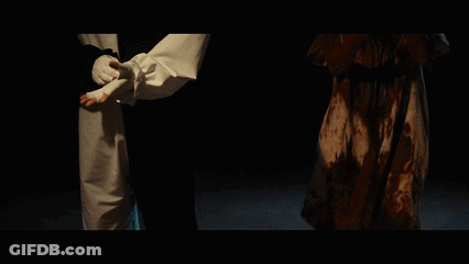 Clown And Woman With Blood On Faces In Dark Room GIF