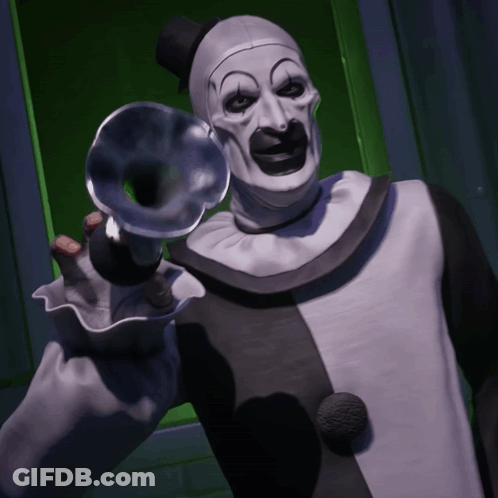 Clown Holding Trumpet In Front Of Green Door GIF