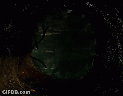 Clown In Dark Room With Brick Wall GIF