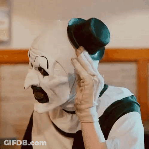 Clown In White Mask Talking On Cell Phone GIF