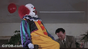 Clown Next To Man In Suit And Tie GIF