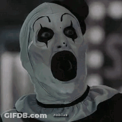 Clown Sitting At Table With Hands Folded GIF