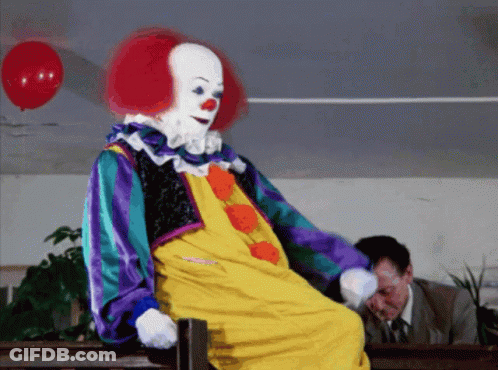 Clown Sitting On Bench With Red Balloon GIF