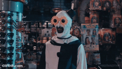 Clown Standing In Front Of Sunglasses Display GIF