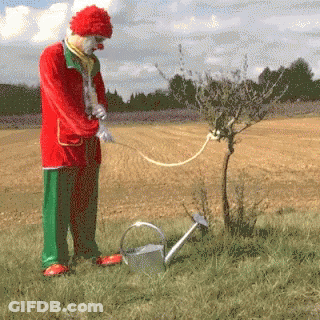 Clown Watering Tree With Can GIF