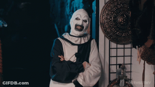 Clown With Arms Crossed In Front Of Rothsothy Sign GIF