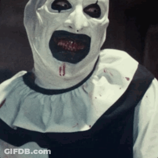 Clown With Blood Coming Out Of Mouth In White And Black Outfit GIF
