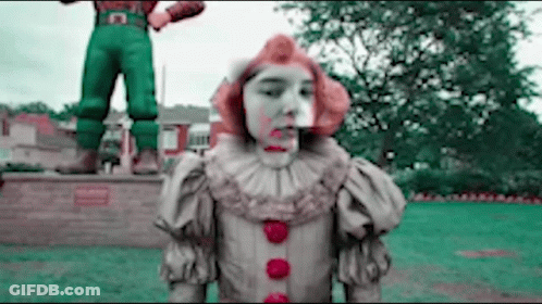 Clown With Blood On Face In Front Of Man Statue GIF