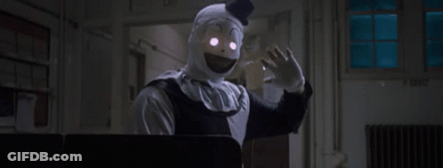 Clown With Glowing Eyes Hand Outstretched GIF