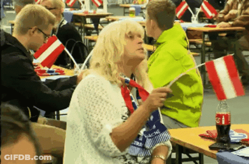 Coca Cola Bottle Next To Woman Holding Flag GIF