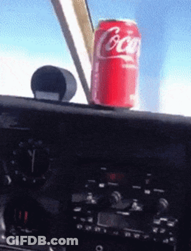 Coca Cola Can On Plane Dashboard GIF