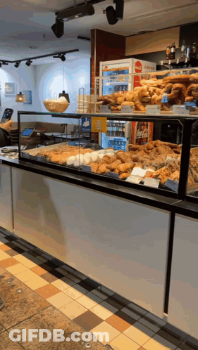 Coca Cola Fridge Behind Pastry Display GIF