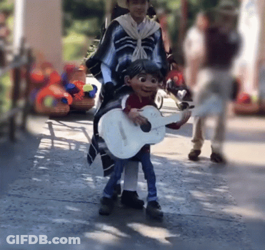 Coco Miguel Playing Guitar While Marching GIF