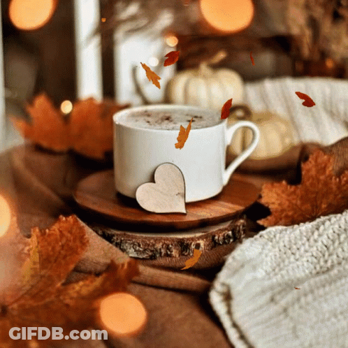 Coffee Cup On Wooden Saucer With Falling Leaves GIF