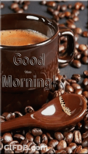 Coffee Cup Surrounded By Beans And Spoon With Butterfly GIF