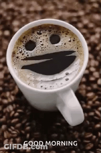 Coffee Cup With Smiley Face Foam On Coffee Beans GIF